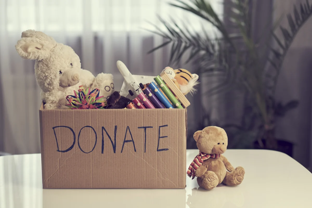 Donation box filled with new toys, books and a teddy bear