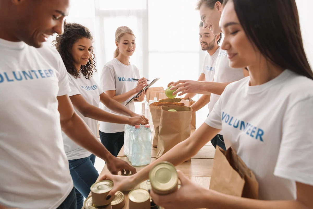 Volunteers packing donations into paper bags