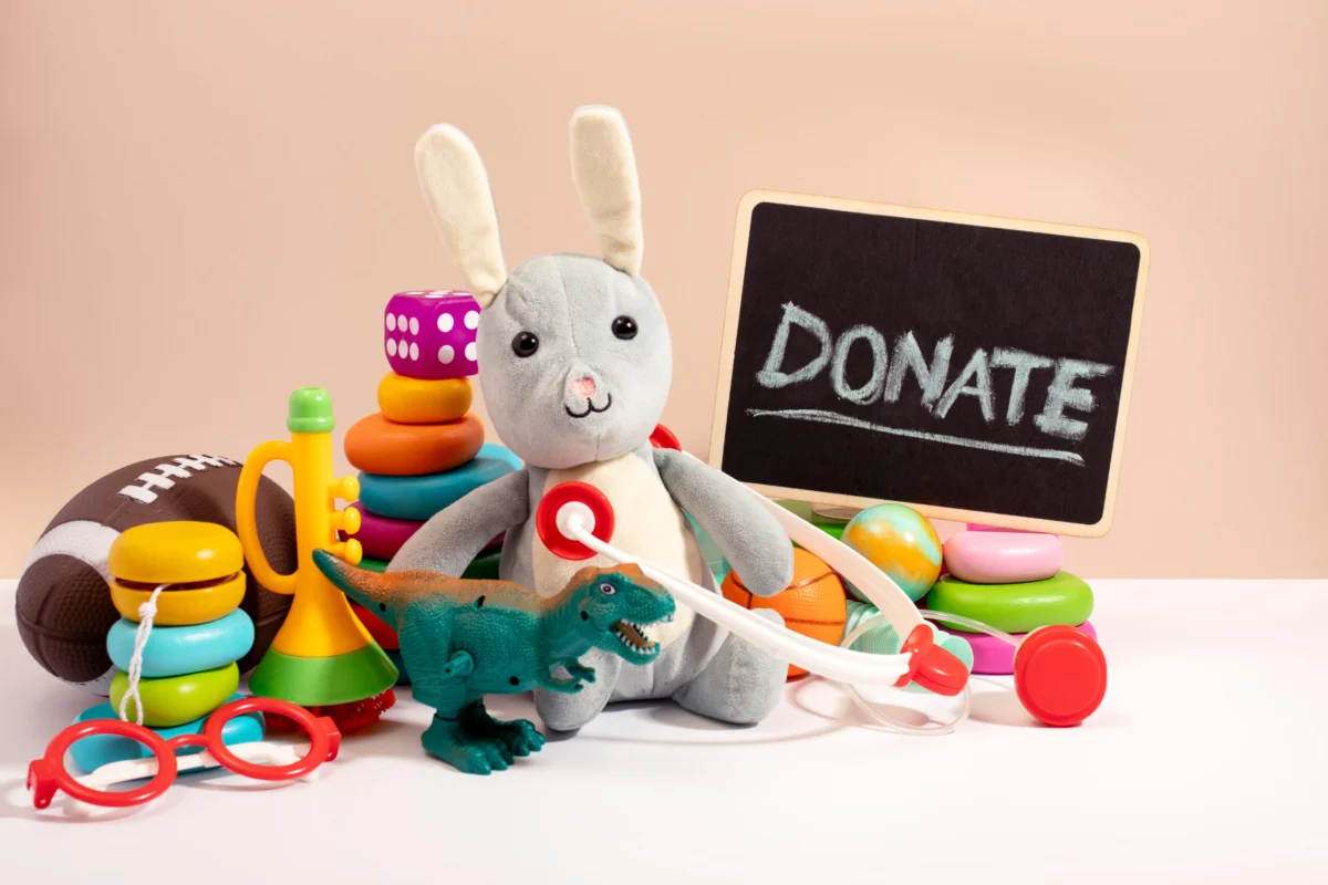 New toys including stacking rings and a plush bunny beside a Donate sign