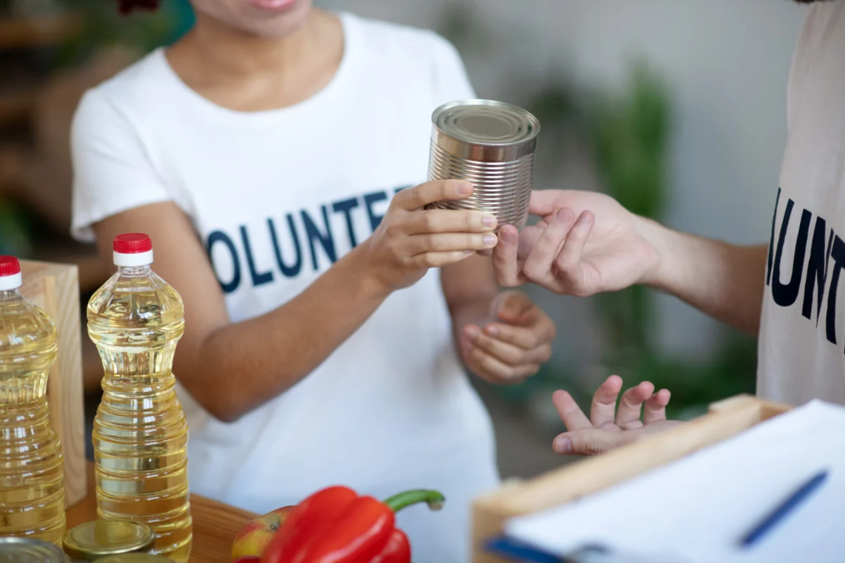 Volunteers packing canned food for families in need